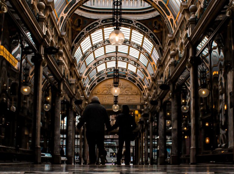 Best places to live in Leeds: A couple walking through the ornate Victorian Quarter arcade.