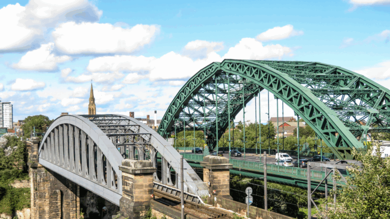 A wide shot of Sunderland's two bridges crossing a river with a church spire in the background.